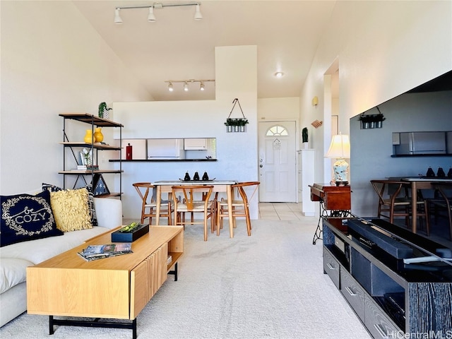 carpeted living room with rail lighting