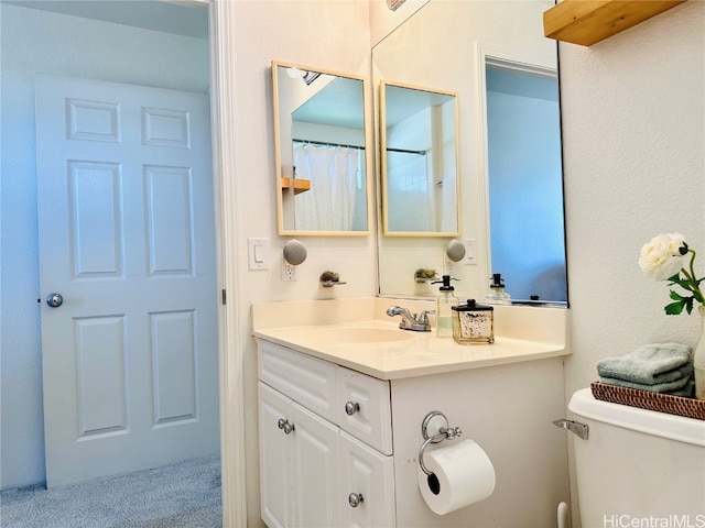 bathroom with vanity and toilet