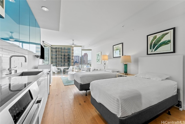 bedroom with light hardwood / wood-style floors and sink