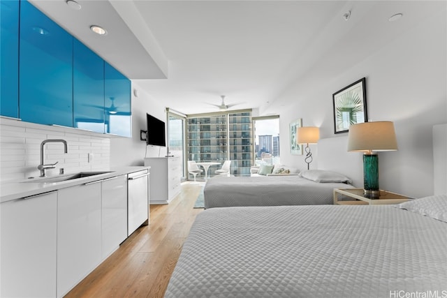 bedroom featuring light hardwood / wood-style flooring and sink