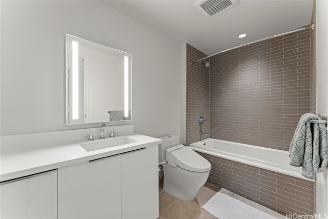 full bathroom with tile patterned flooring, vanity, toilet, and tiled shower / bath