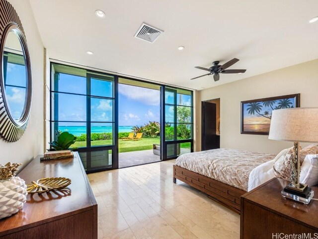 bedroom featuring expansive windows and access to outside