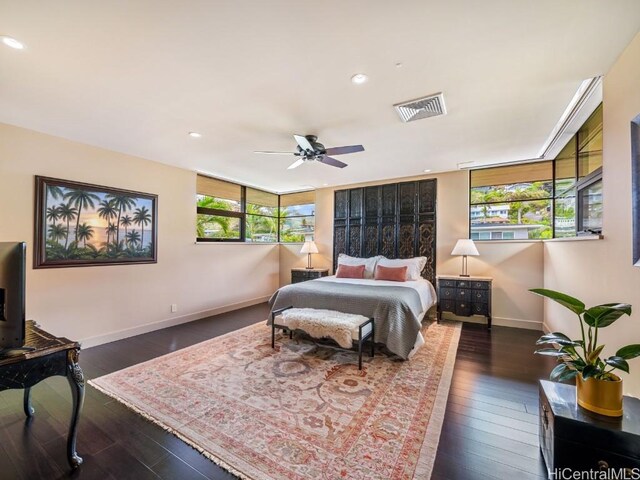 bedroom featuring dark wood-type flooring, ceiling fan, and multiple windows