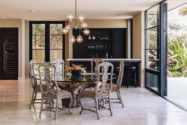 dining area featuring expansive windows, beverage cooler, a chandelier, and light hardwood / wood-style floors