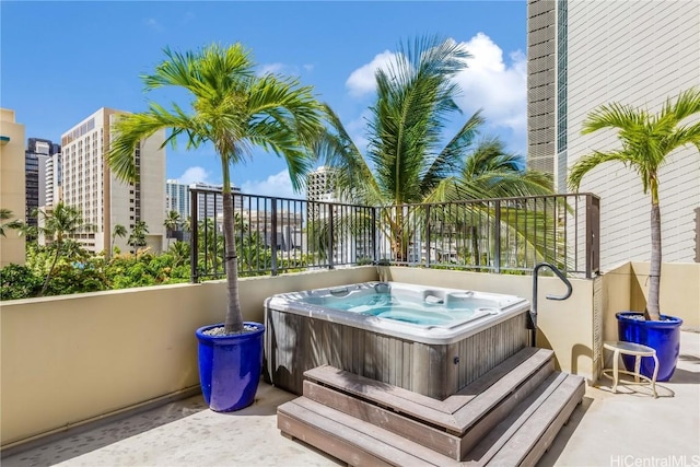 exterior space featuring an outdoor hot tub