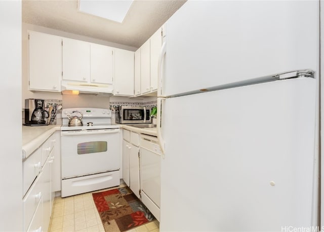 kitchen featuring white cabinetry and white appliances