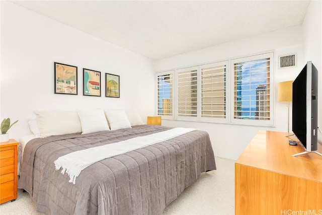 bedroom featuring light colored carpet