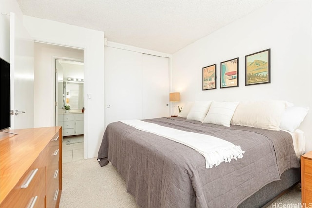 bedroom featuring a closet and light colored carpet