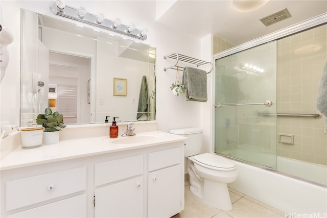 full bathroom featuring vanity, enclosed tub / shower combo, toilet, and tile patterned floors