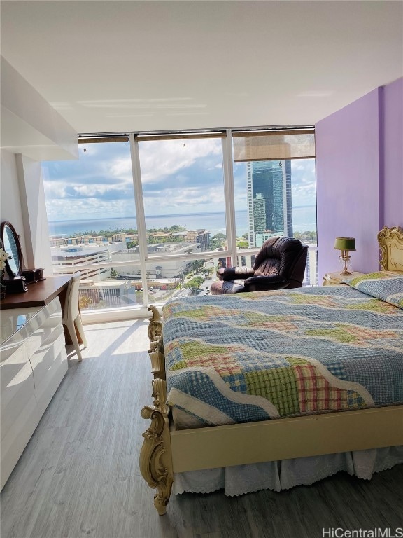 bedroom featuring floor to ceiling windows and hardwood / wood-style floors