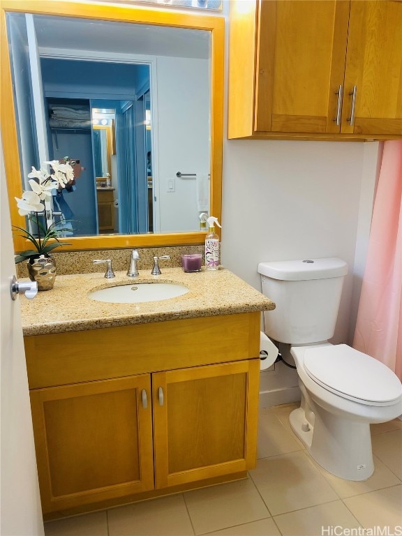 bathroom with vanity, toilet, and tile patterned flooring