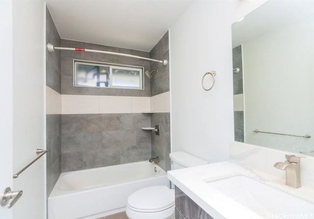 full bathroom with vanity, toilet, and tiled shower / bath