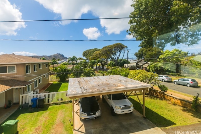 view of yard featuring a mountain view and a carport