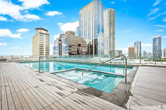 view of swimming pool with a community hot tub