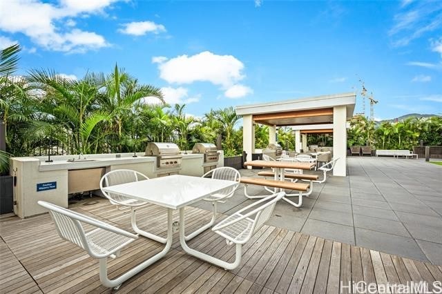 wooden terrace featuring area for grilling