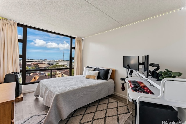 bedroom featuring a textured ceiling and hardwood / wood-style flooring