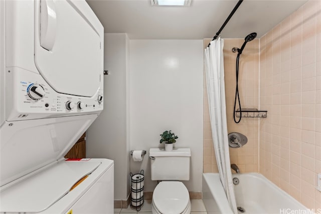 bathroom with tile patterned floors, shower / bathtub combination with curtain, toilet, and stacked washing maching and dryer