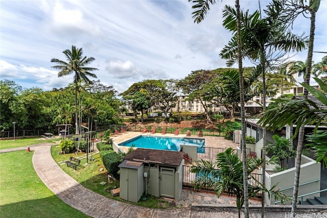 view of pool featuring a lawn