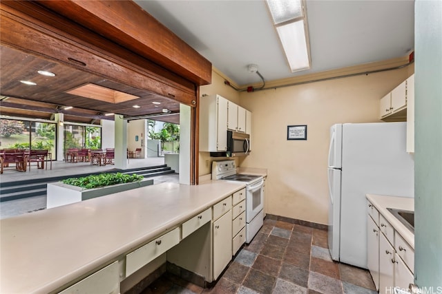 kitchen featuring white cabinets, sink, and white appliances