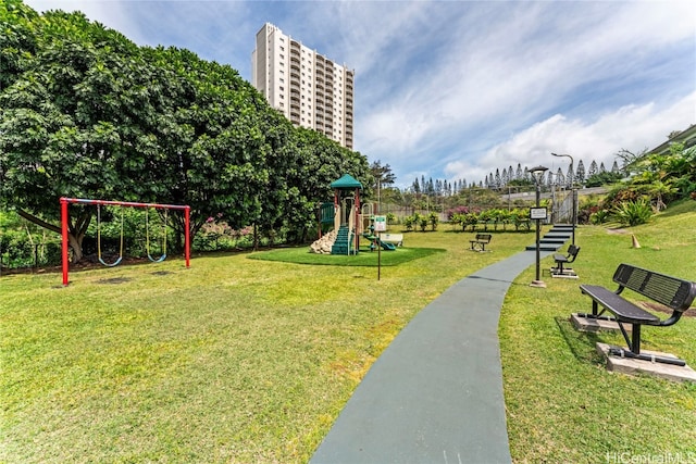 view of home's community featuring a lawn and a playground