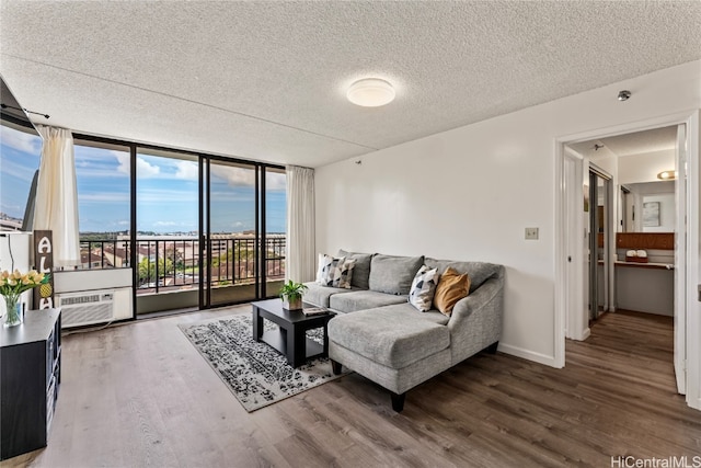 living room featuring a textured ceiling, dark hardwood / wood-style flooring, and a wall of windows