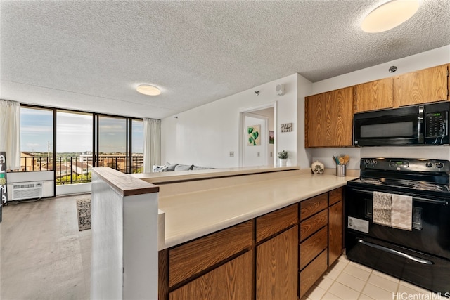 kitchen with kitchen peninsula, a textured ceiling, black appliances, and light tile patterned floors