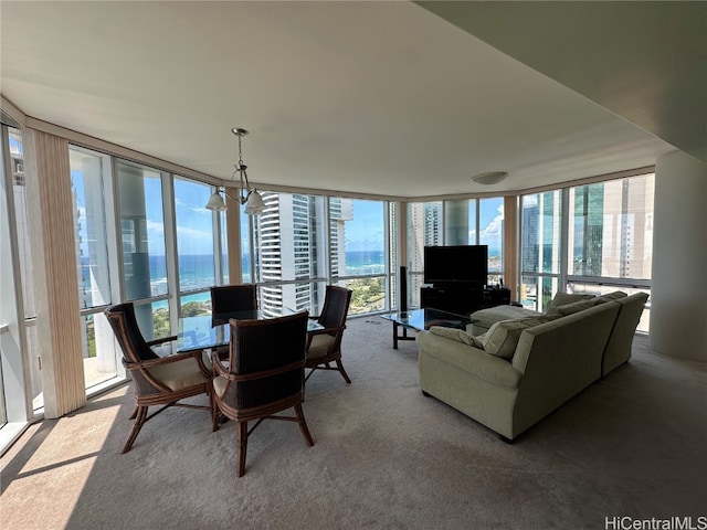 interior space featuring expansive windows, carpet flooring, and a chandelier