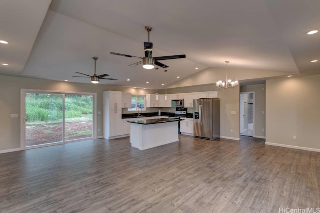 kitchen with appliances with stainless steel finishes, a center island, white cabinetry, pendant lighting, and hardwood / wood-style flooring