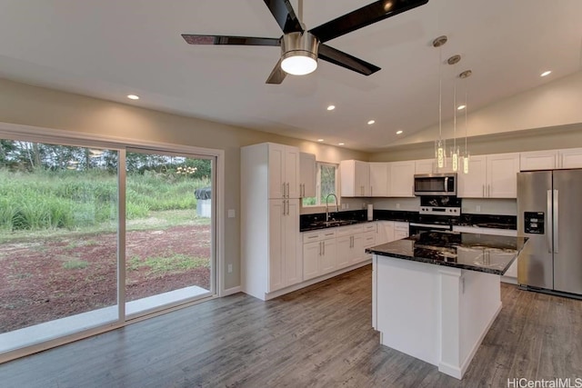 kitchen with white cabinetry, appliances with stainless steel finishes, a center island, and hanging light fixtures