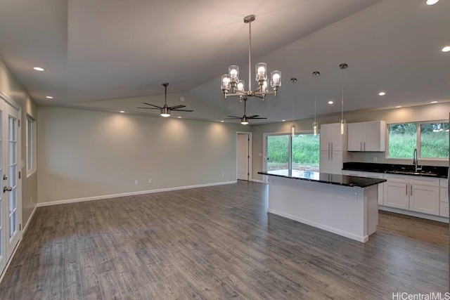 kitchen featuring sink, white cabinetry, decorative light fixtures, and plenty of natural light