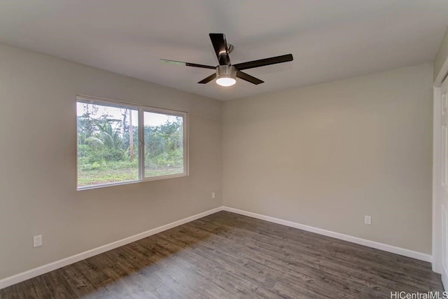 unfurnished room with dark wood-type flooring and ceiling fan