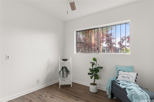 unfurnished room with ceiling fan and dark wood-type flooring