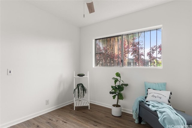 unfurnished room featuring ceiling fan, baseboards, and wood finished floors