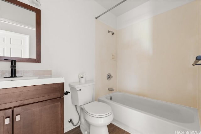 bathroom featuring  shower combination, toilet, wood finished floors, and vanity