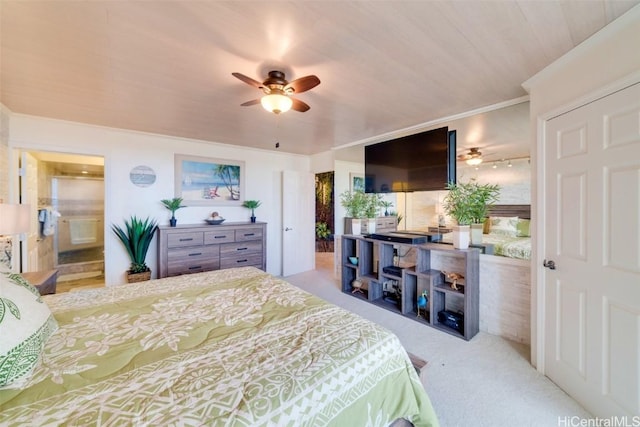 bedroom with light colored carpet, ensuite bath, and ceiling fan