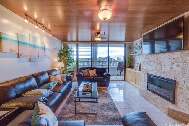 tiled living room with a fireplace, ceiling fan, wooden ceiling, and rail lighting