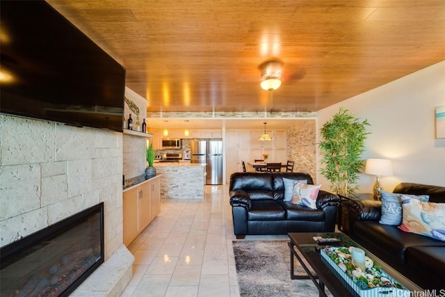 tiled living room featuring ceiling fan and wood ceiling