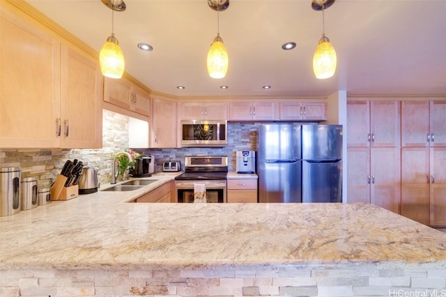 kitchen featuring tasteful backsplash, sink, decorative light fixtures, and appliances with stainless steel finishes