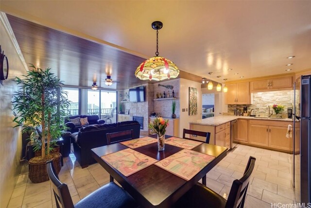 dining area with ceiling fan and sink