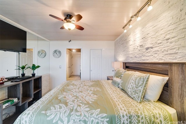 bedroom featuring ceiling fan and track lighting