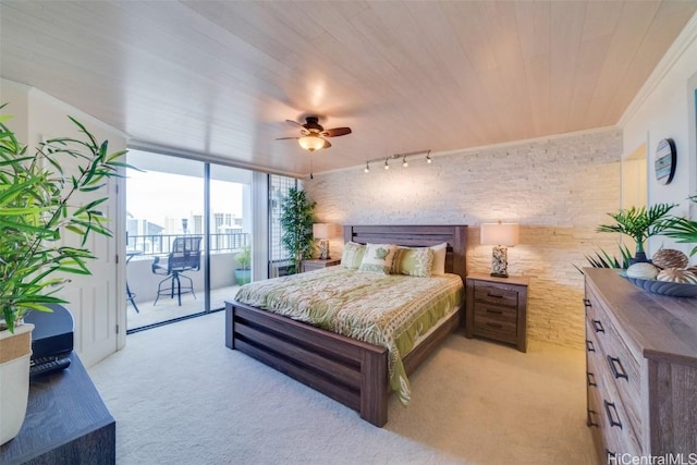 bedroom featuring wooden ceiling, access to outside, track lighting, ceiling fan, and brick wall