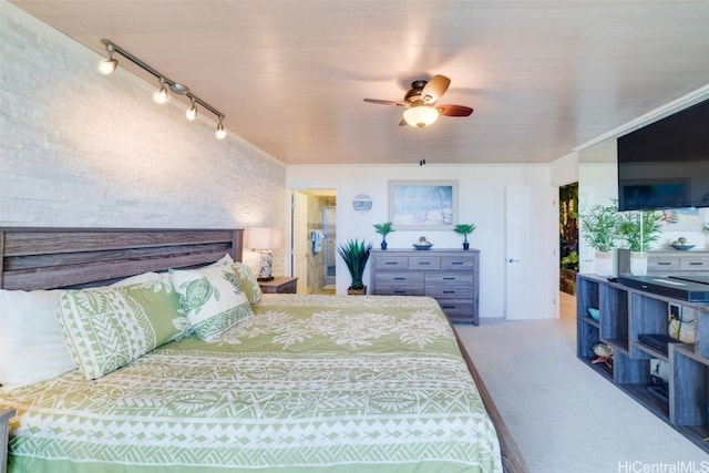 carpeted bedroom featuring rail lighting and ceiling fan