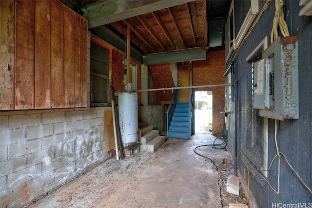 misc room featuring gas water heater and concrete flooring