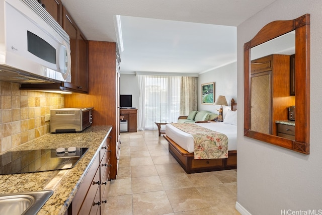 bedroom with ornamental molding and light tile patterned flooring