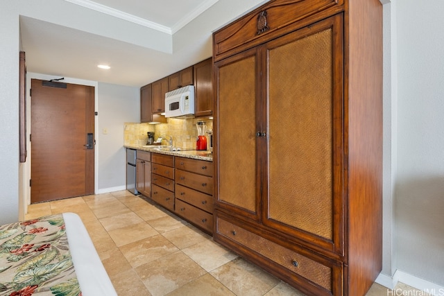 kitchen featuring crown molding, tasteful backsplash, sink, and light stone countertops