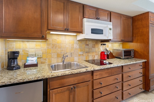 kitchen with black electric cooktop, sink, light tile patterned floors, and backsplash