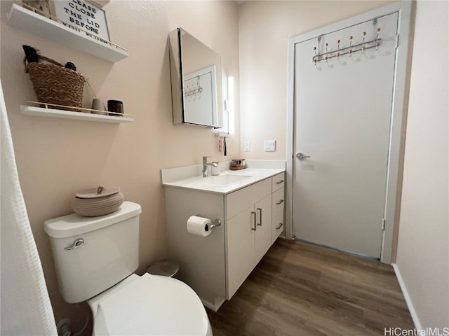 bathroom featuring vanity, hardwood / wood-style floors, and toilet