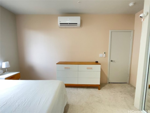 bedroom with an AC wall unit and light carpet