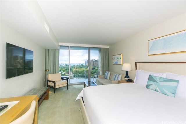 carpeted bedroom featuring floor to ceiling windows