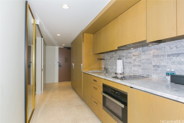 kitchen featuring decorative backsplash, exhaust hood, light stone countertops, light tile patterned floors, and appliances with stainless steel finishes